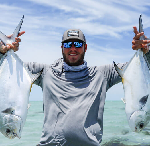 An image of an Outgoing Angling fisherman with twin permit in the Florida keys. 